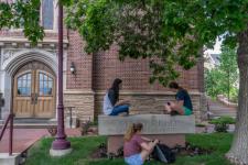 Students sitting outside building