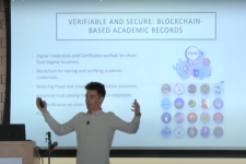 Matt Romo Nichols, DU student, talks about blockchain in front of powerpoint presentation