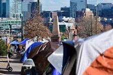 row of tents overlooking denver city centre 