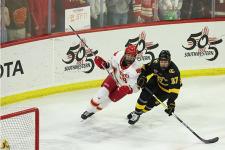 A DU hockey player defends a Colorado College player