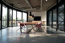 open air office with chairs around rectangular desk as light pours in the room