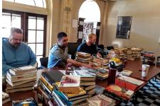 Parolees process books for their library