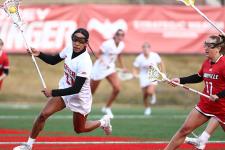 Trinity McPherson runs across the field with the ball