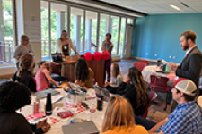 group of people speaking to others in a room