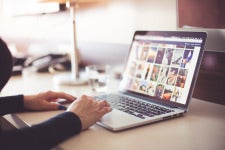 stock image of hands working on a laptop 