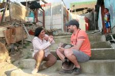 Nikolai Alvarado sitting the steps with a local woman