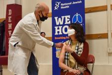 Doctor giving covid vaccine to patient