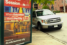 advertisement for DU summer session next to a car