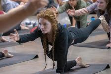 A student performs a yoga position at the Kennedy Mountain Campus.