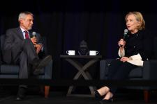 Hillary Clinton speaks with Fritz Mayer on stage.