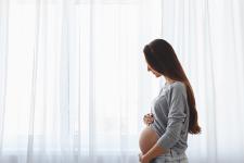 pregnant woman cradling belly