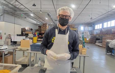 Students from the Fritz Knoebel School of Hospitality Management volunteer at the women's bean project