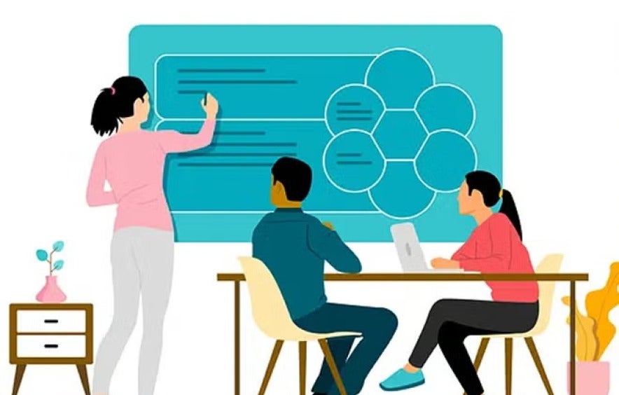 three people working on a board