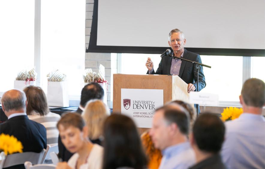 DU chancellor speaks at lectern