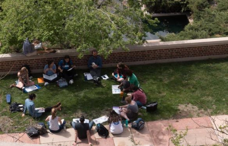 class gathers in a circle outside