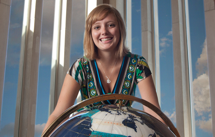 woman standing over globe