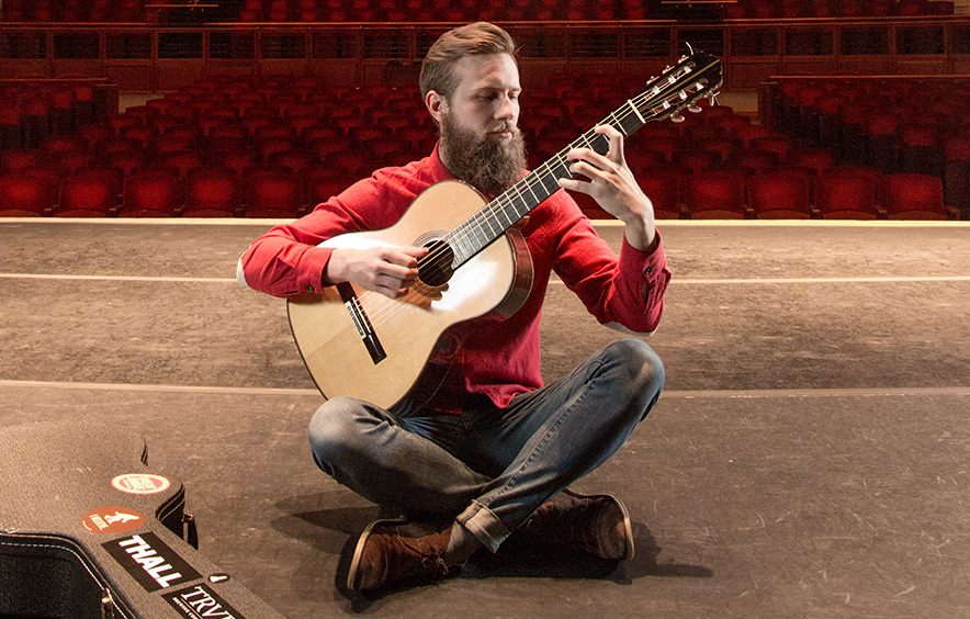 man playing acoustic guitar