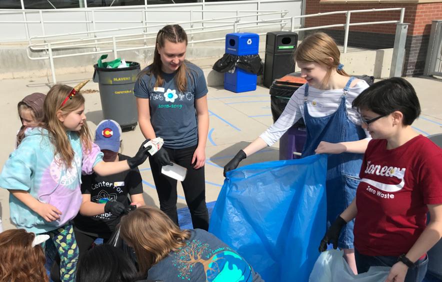 group of students and children picking up waste