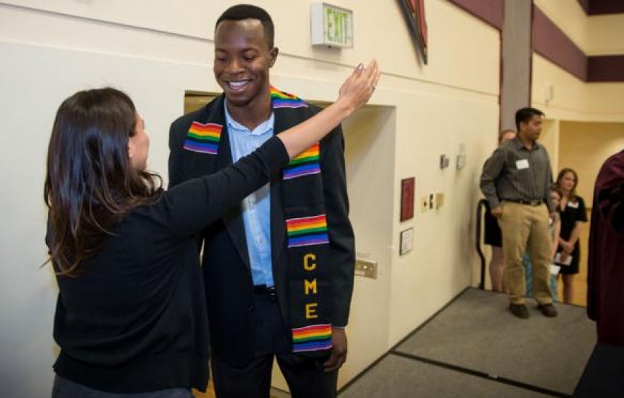 diverse students reach for hug