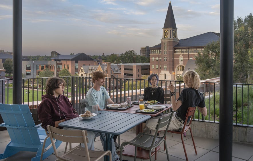 students sitting talking at a table