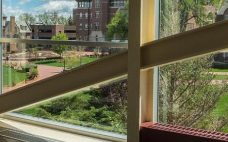 student walks through the Driscoll covered walkway