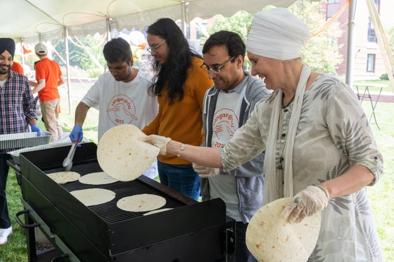 four people getting meal at langar