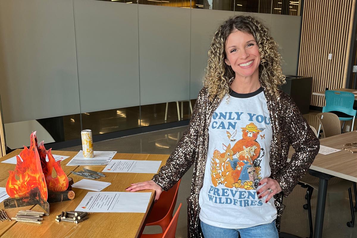 Woman standing with a shirt that has text that says only you can prevent wildfires