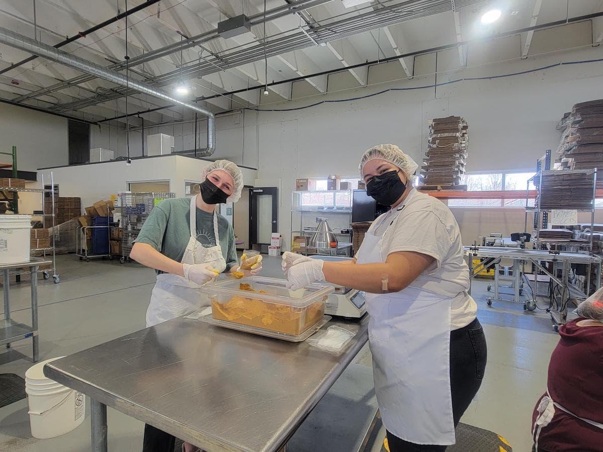 Students from the Fritz Knoebel School of Hospitality Management volunteer at the women's bean project