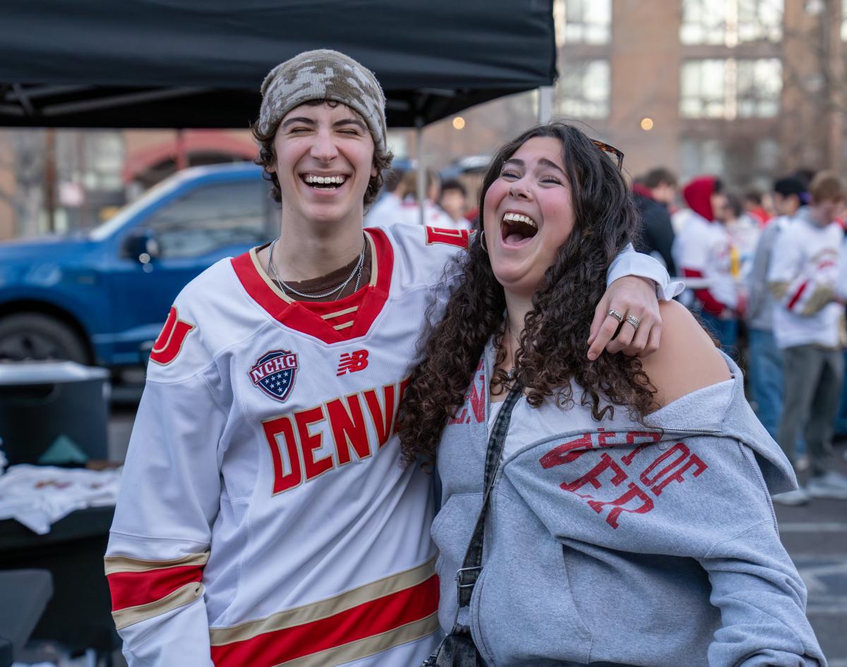 students laugh together at hockey tailgate