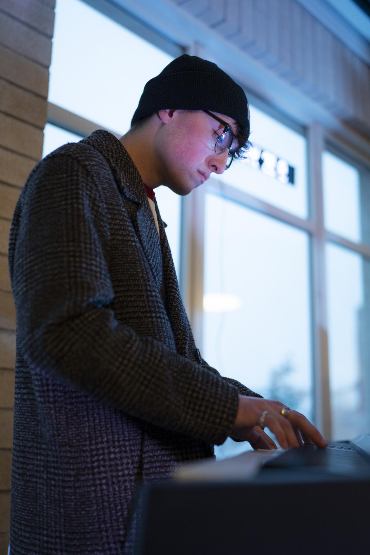 A student plays the keyboard.