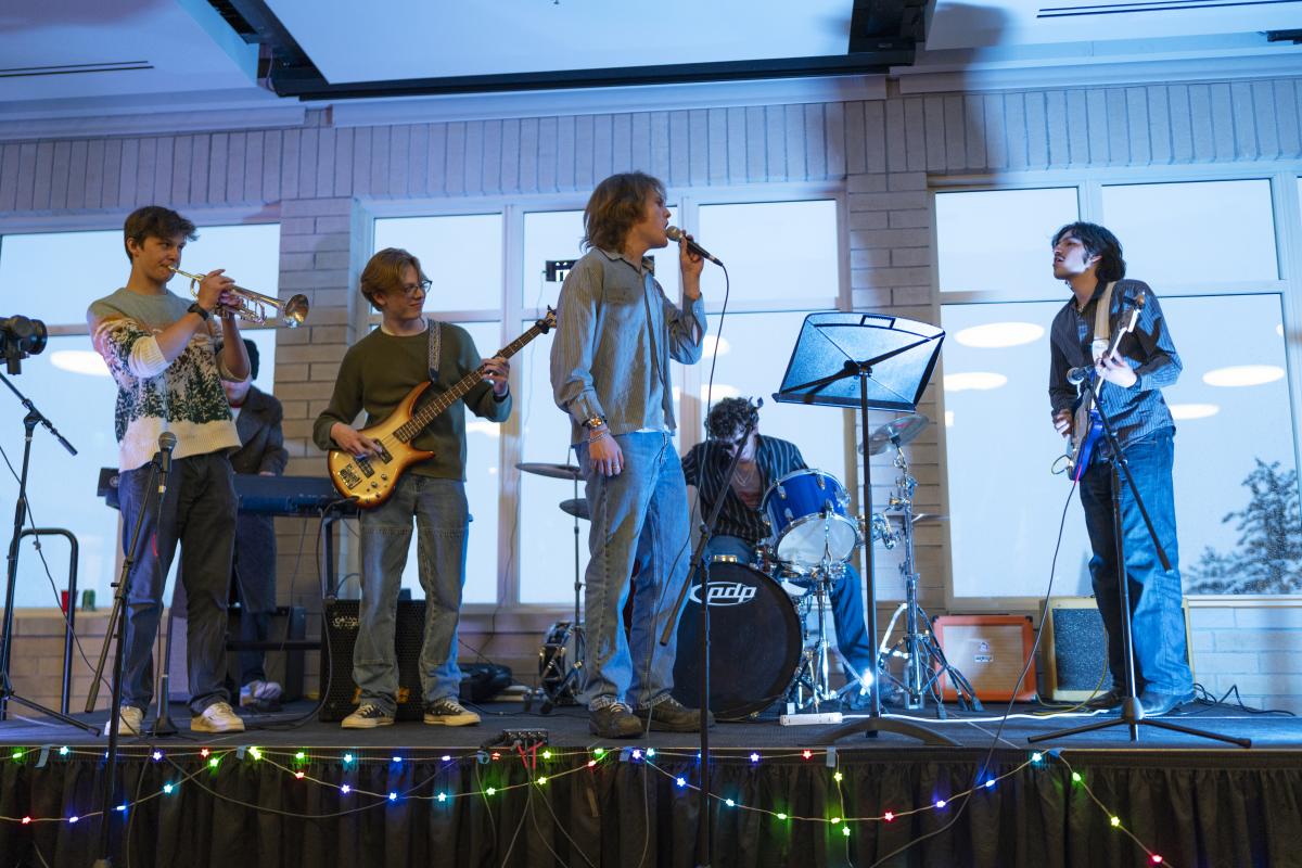 A student band rocks the "Battle of the Bands" stage.