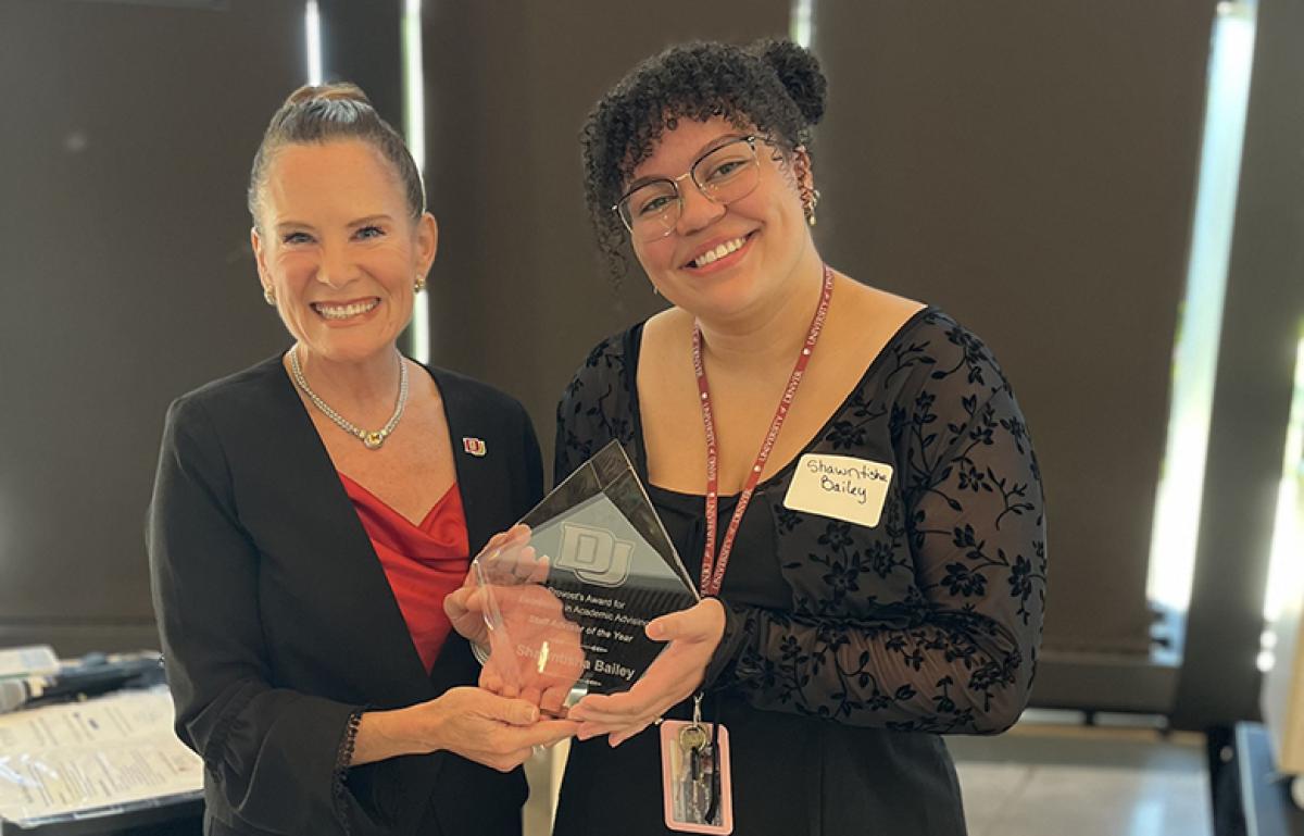 Elizabeth Loboa poses with Shawntisha Bailey as she accepts her award for Staff Advisor of the Year.