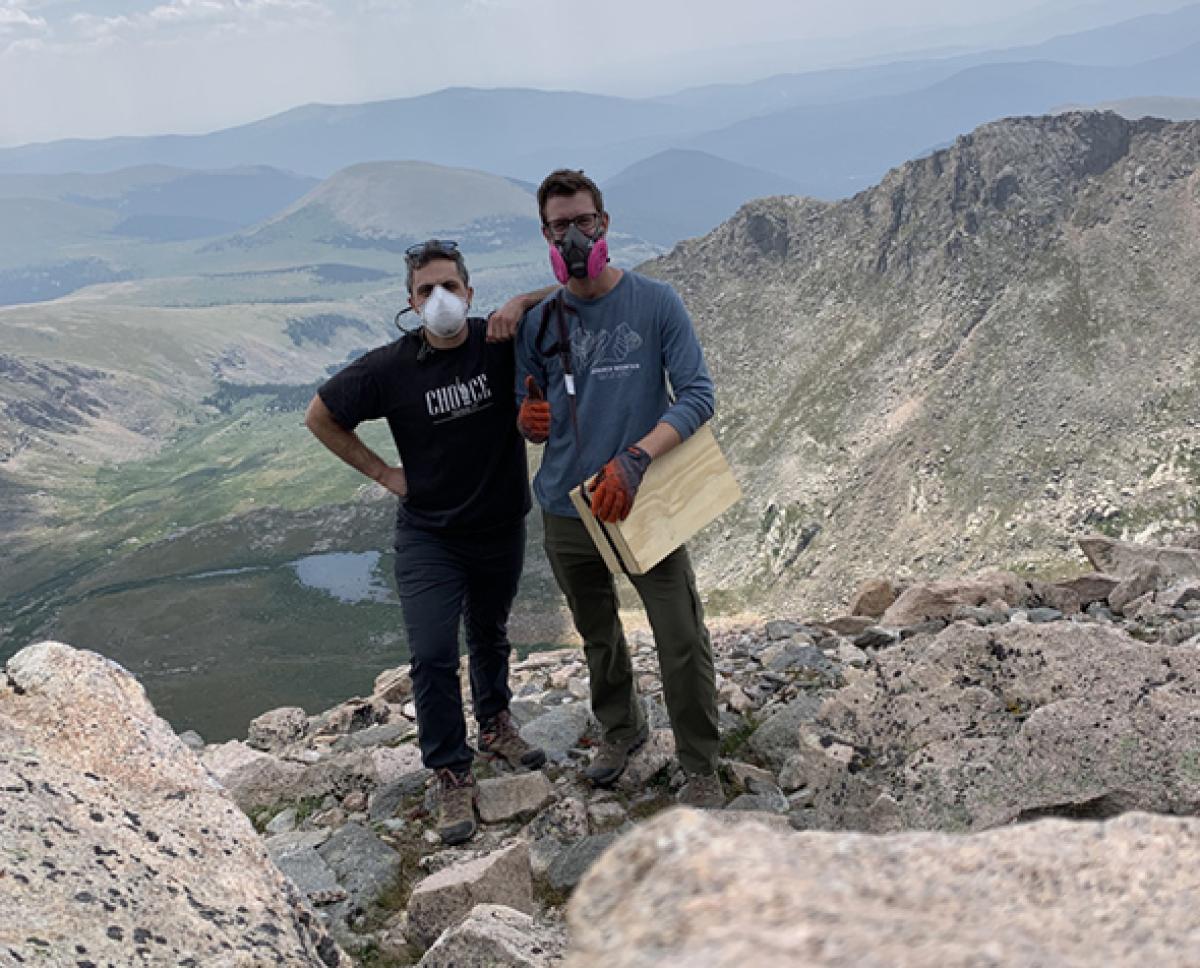 Researchers Jonathan Velotta and Peter Nimlos pose atop Mount Evans