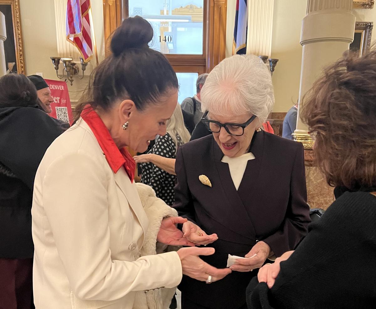 Provost Loboa hands a DU pin to holocaust survivor Selma Sladek.