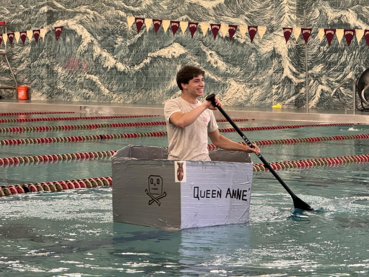 A student in Dr. Keith Miller's First-Year Seminar, "Pirates: Sailors, Science, and Society" experiencing joy testing a handmade "sloop" in the Ritchie Center pool.