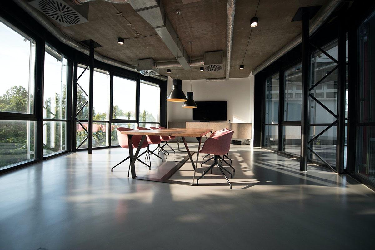 open air office with chairs around rectangular desk as light pours in the room
