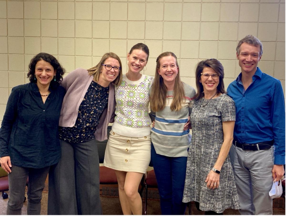 Six people stand and pose for a photo.