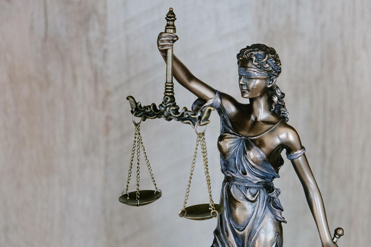 lady justice holding scales with a blindfold