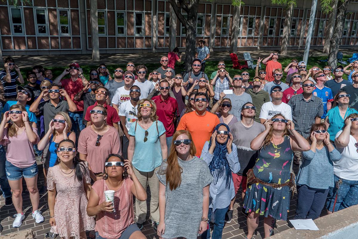 Members of the DU community look up at the solar eclipse
