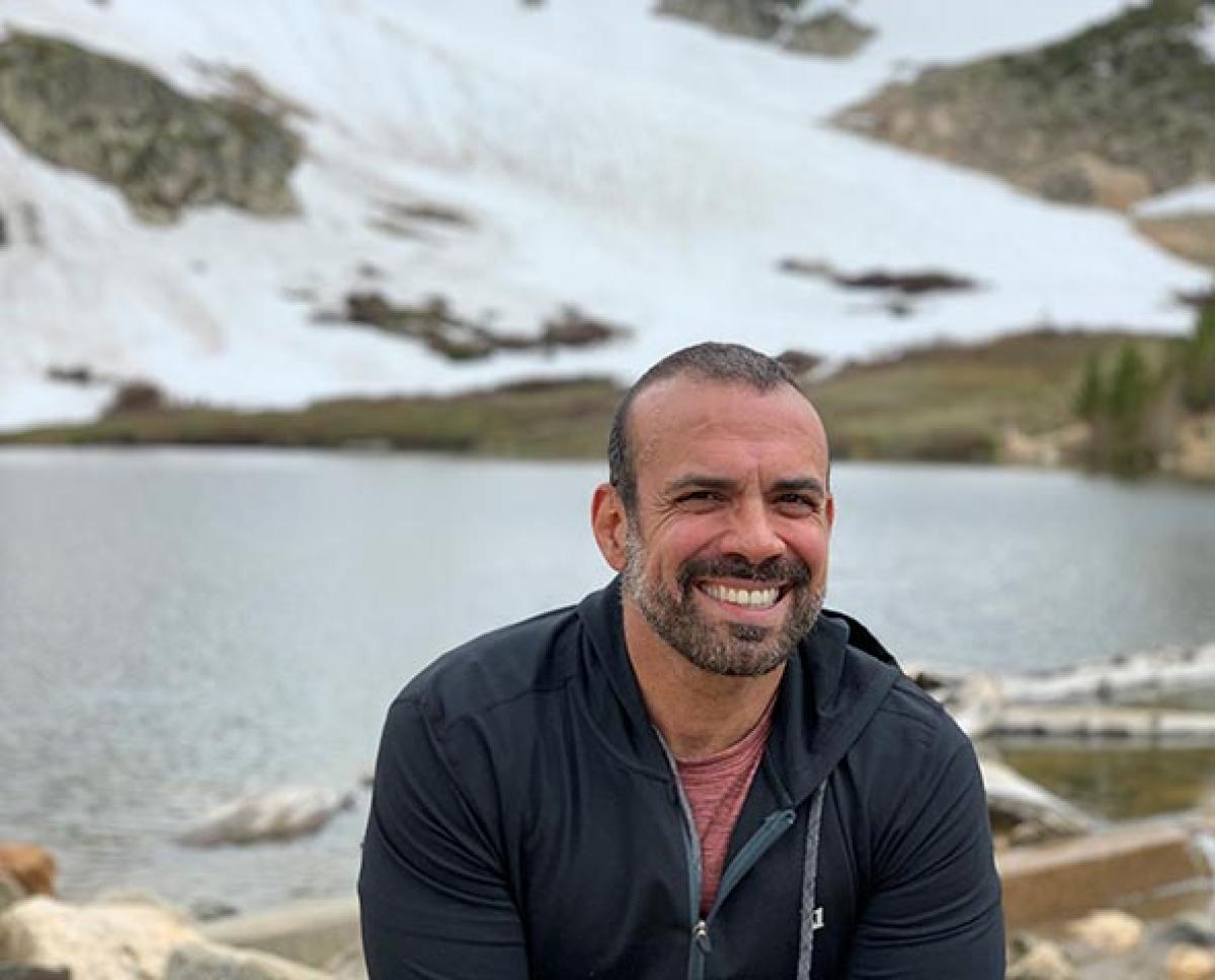 picture of Stephen Fusco smiling in front of a lake