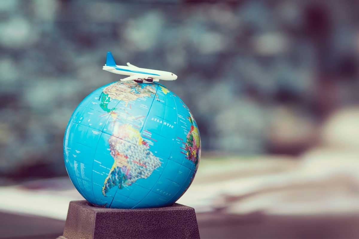 globe with model airliner sitting on top