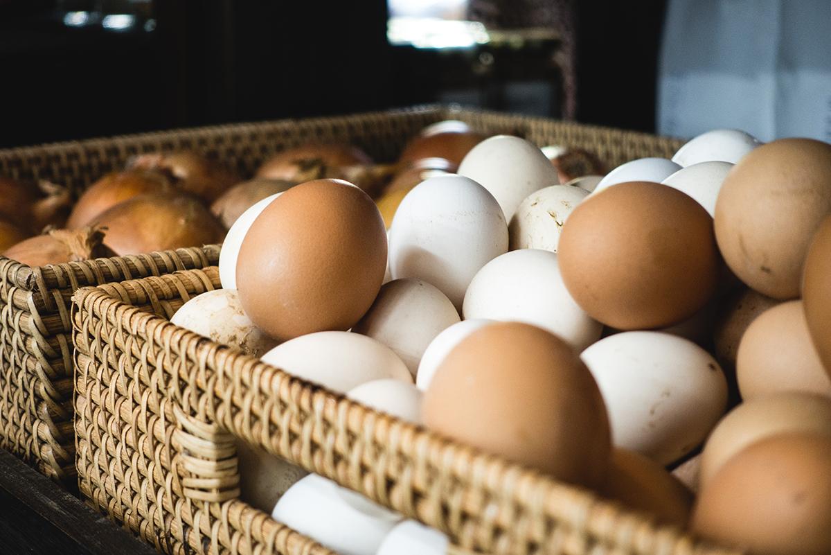 White and brown eggs in a wicker basket
