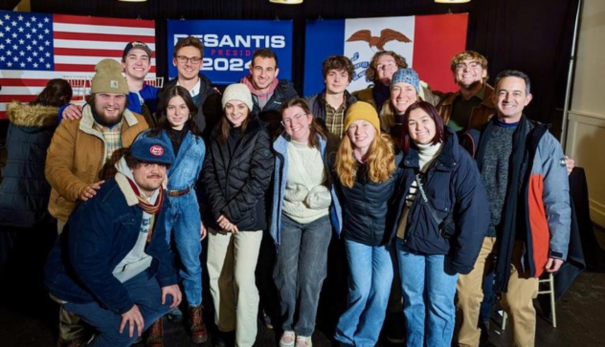 Seth Masket and a group of DU students pose for a group photo during a campaign event at the 2024 Iowa caucuses.