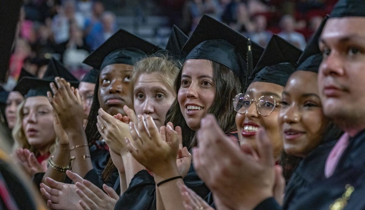 A row of graduates look to the stage at DU's 2023 spring commencement.