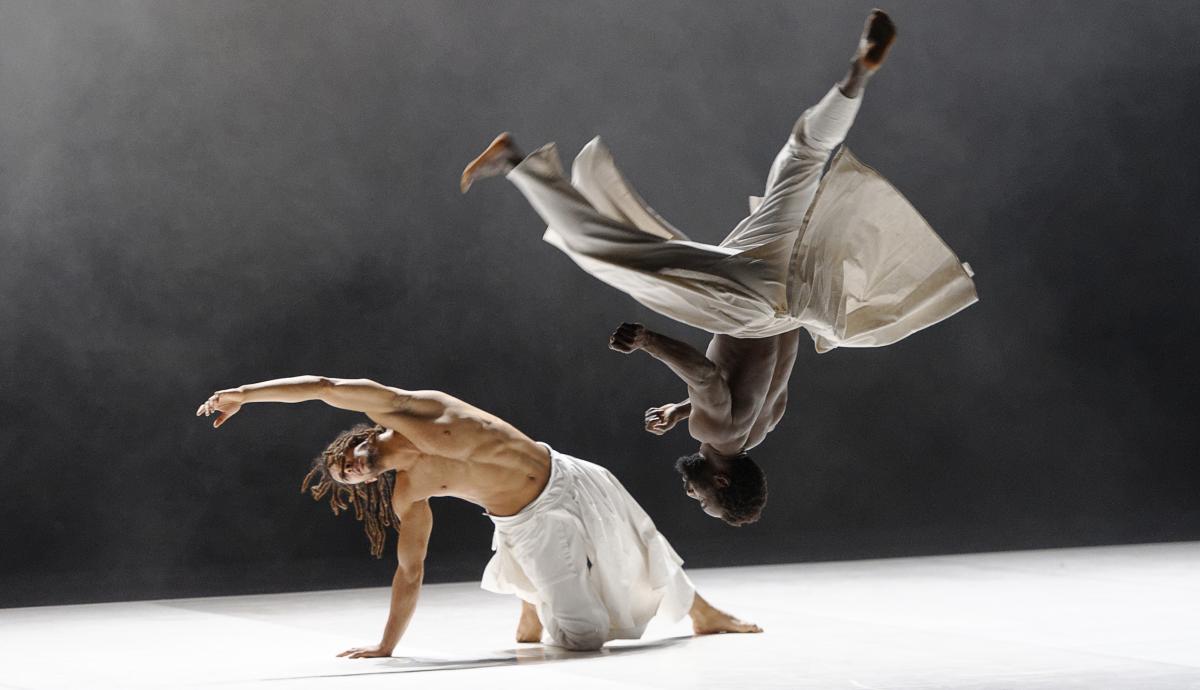Photo of two dancers from the Compagnie Hervé Koubi performing on stage.