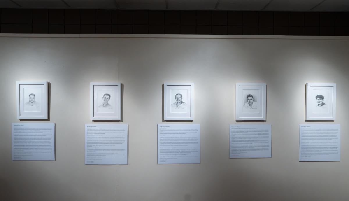 A gallery of drawings of people at the Into Light exhibit at the University of Denver.