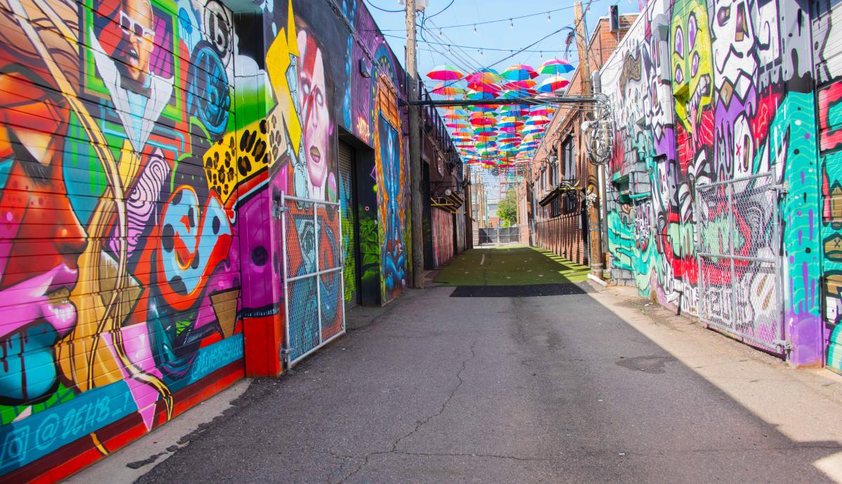 An alleyway adorned with murals in the River North neighborhood of Denver.