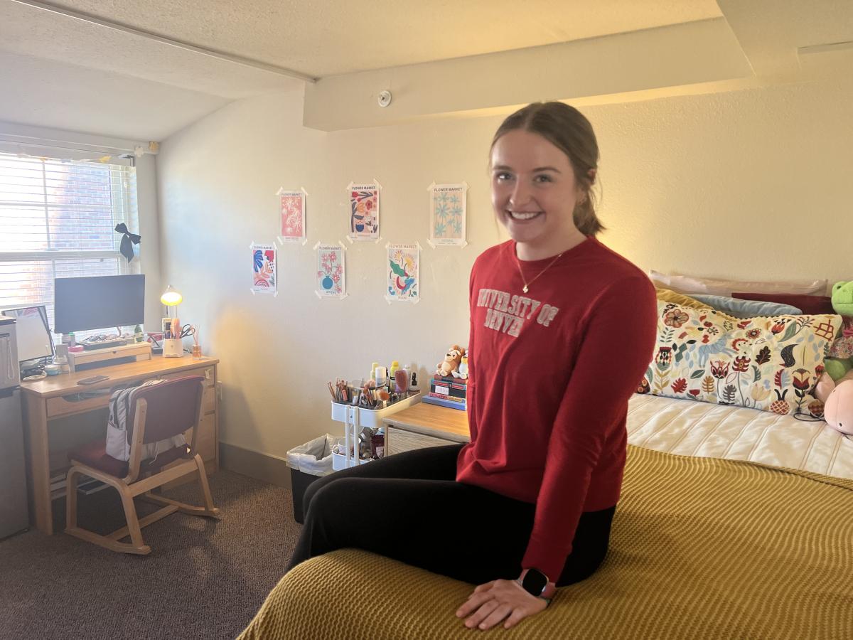 Libby Williamson sits on her bed in her room at the 4D House.