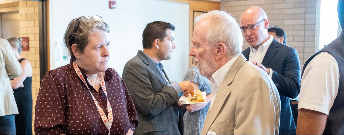 two people talking in a conference