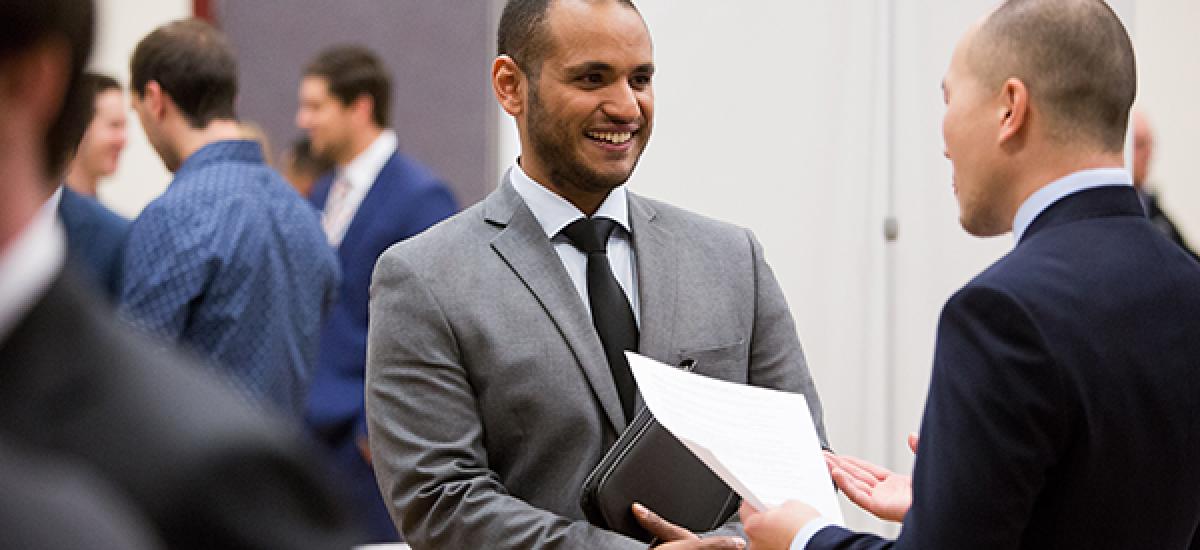 students network at a Daniels College event
